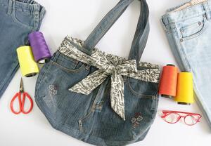 Bild vergrößern: Denim bag and sewing accessories on white background , top view , recycle concept